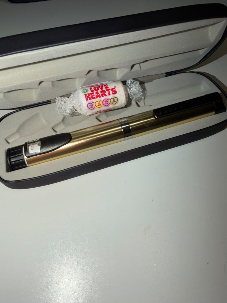 Gold insulin pen in its case